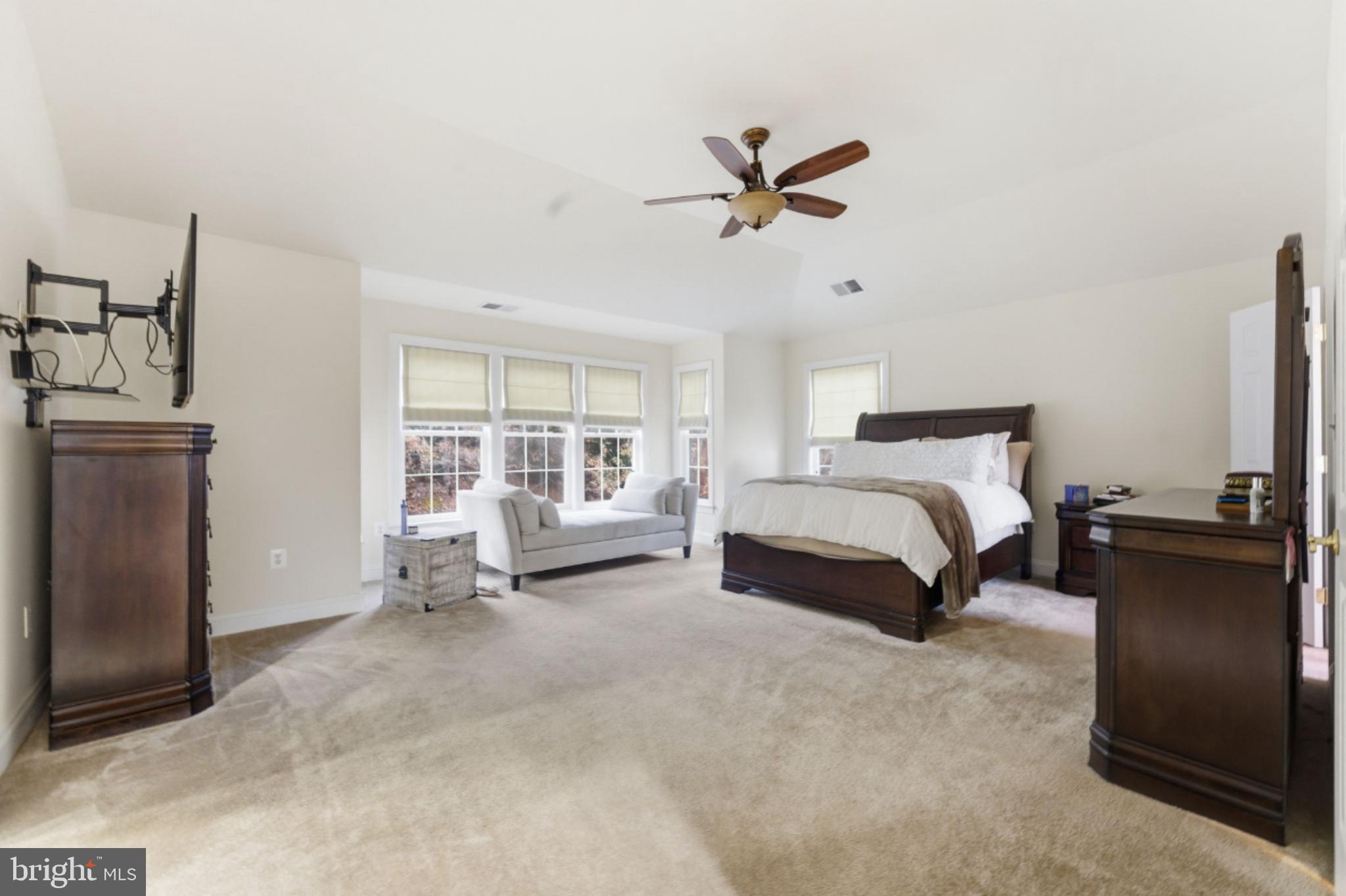 7669 Oak Field Court Springfield, VA 22153 - Photo 29 of 57 a spacious bedroom with a bed and a window