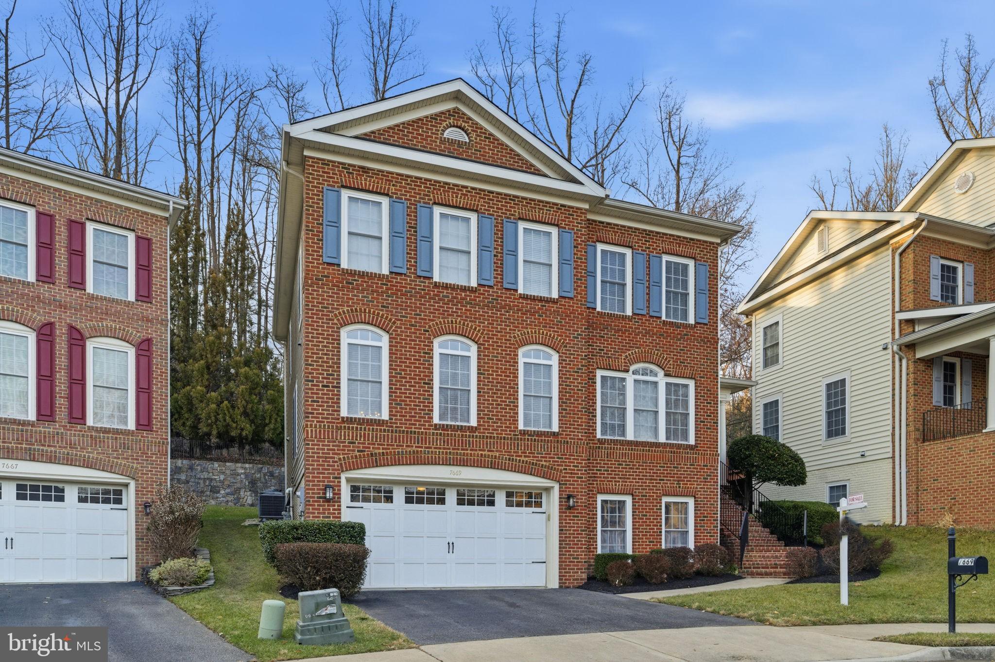 7669 Oak Field Court Springfield, VA 22153 - Photo 3 of 57 a front view of a house with a yard