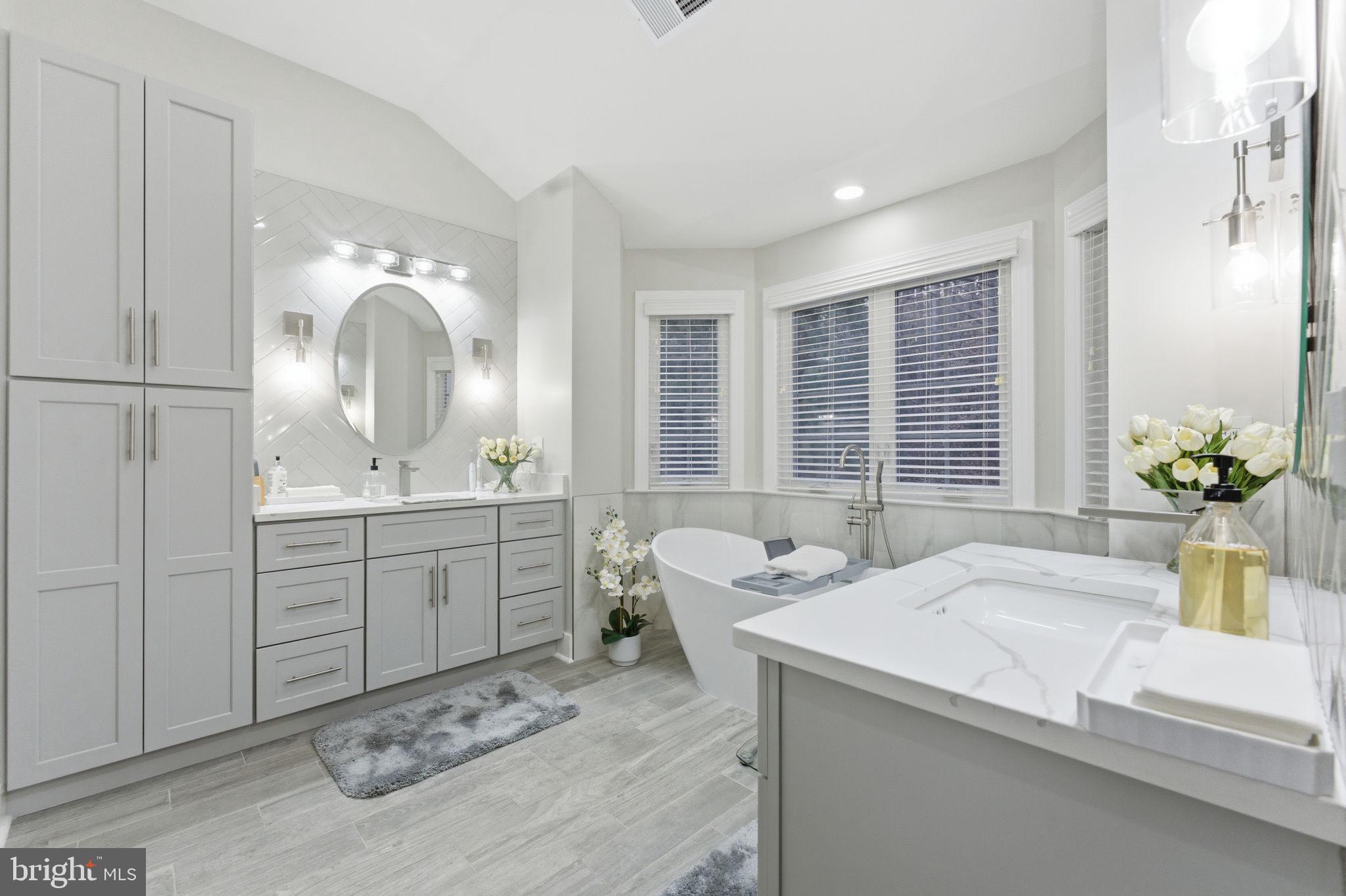 7669 Oak Field Court Springfield, VA 22153 - Photo 31 of 57 a bathroom with a sink and a mirror