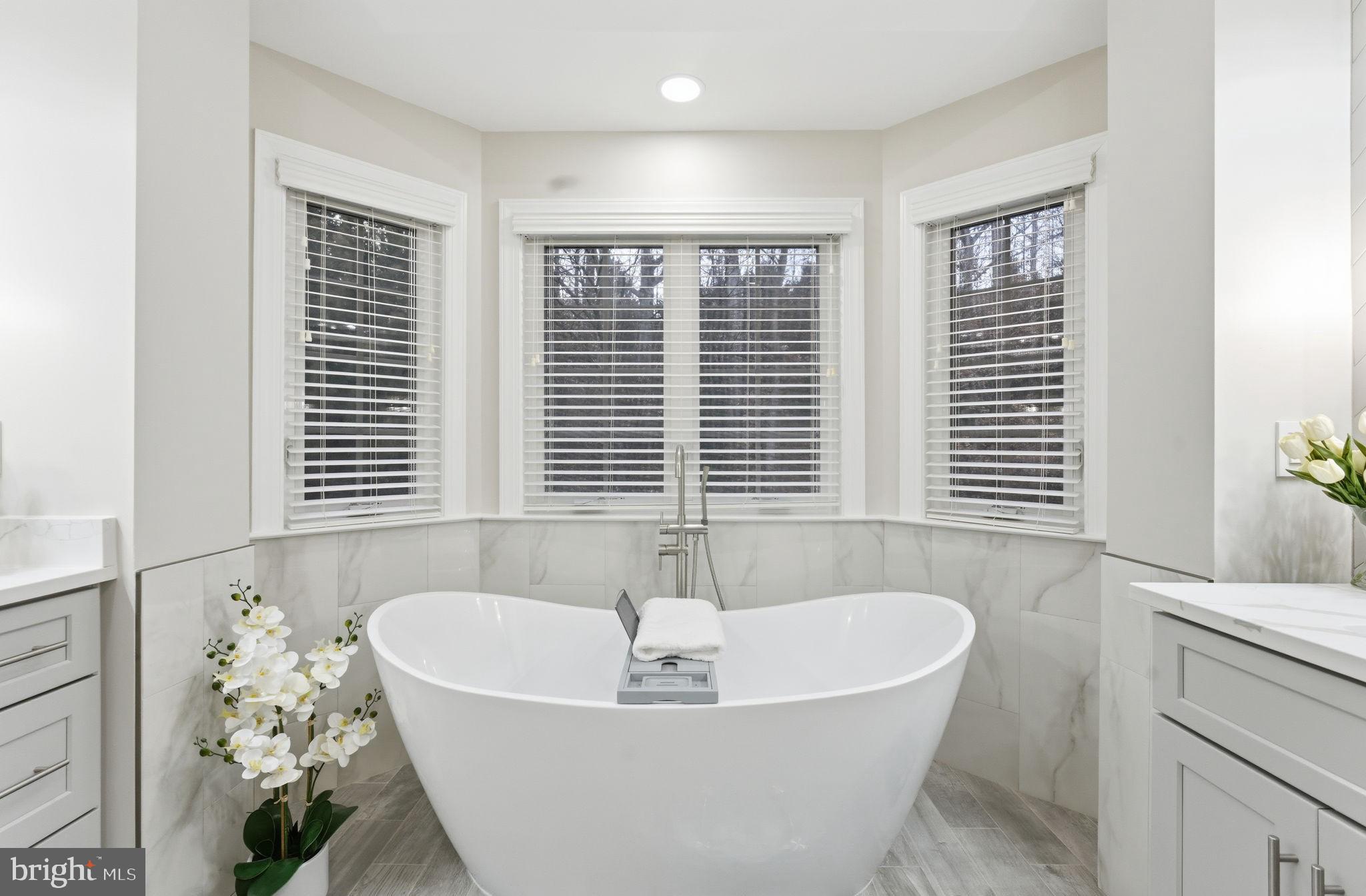 7669 Oak Field Court Springfield, VA 22153 - Photo 32 of 57 a bath tub sitting in a bathroom next to a window