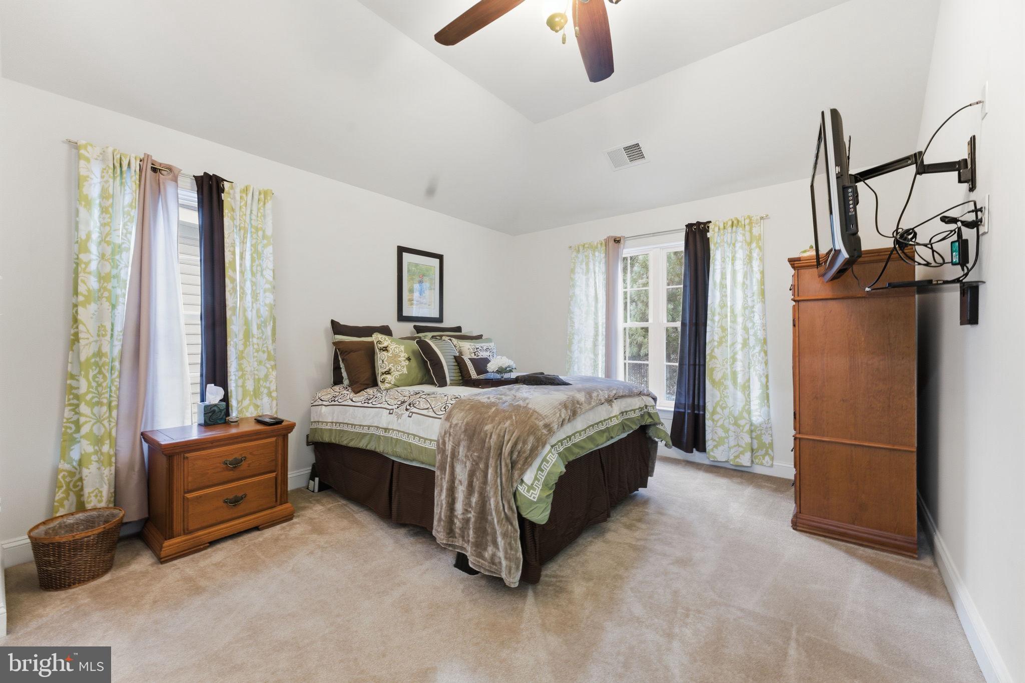 7669 Oak Field Court Springfield, VA 22153 - Photo 34 of 57 a bedroom with a bed closet and a flat tv screen