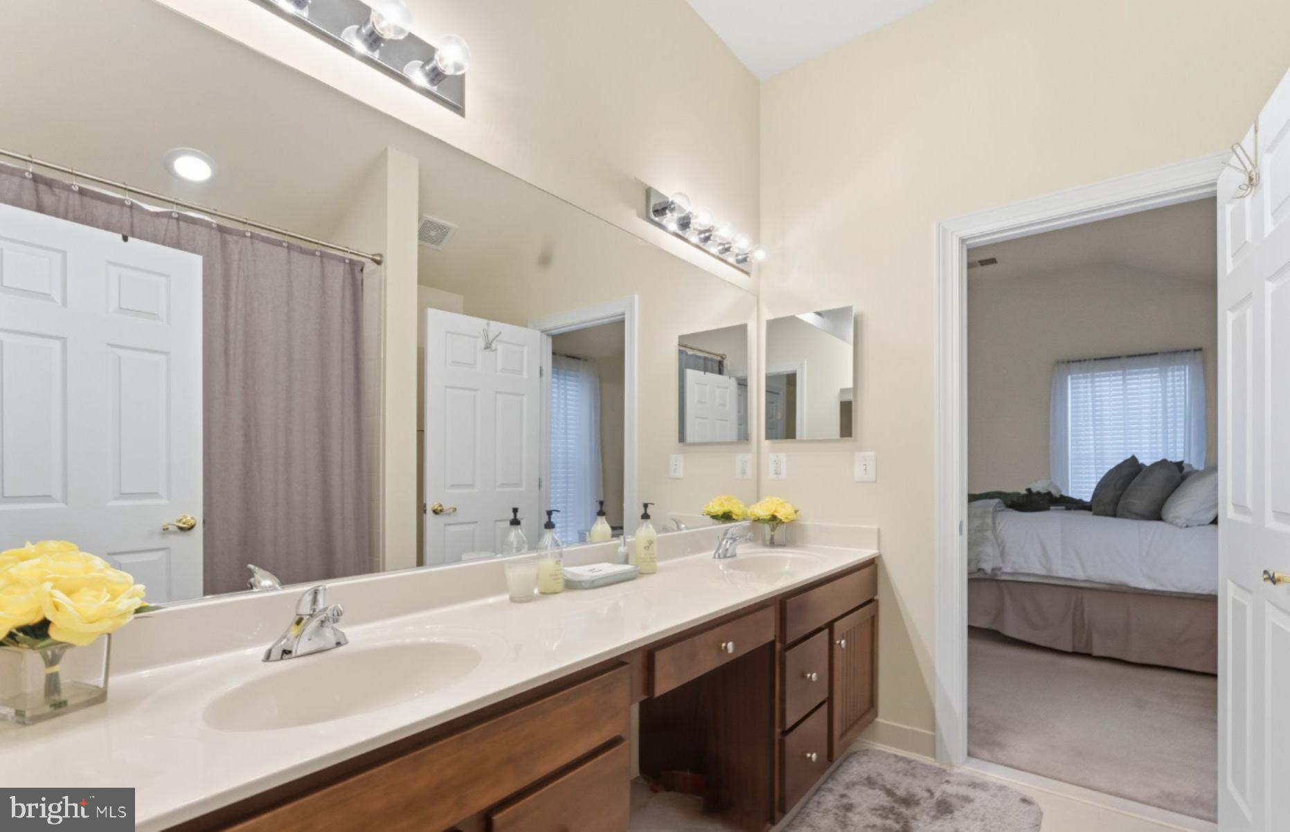 7669 Oak Field Court Springfield, VA 22153 - Photo 36 of 57 a en suite bathroom with a double vanity sink and a mirror
