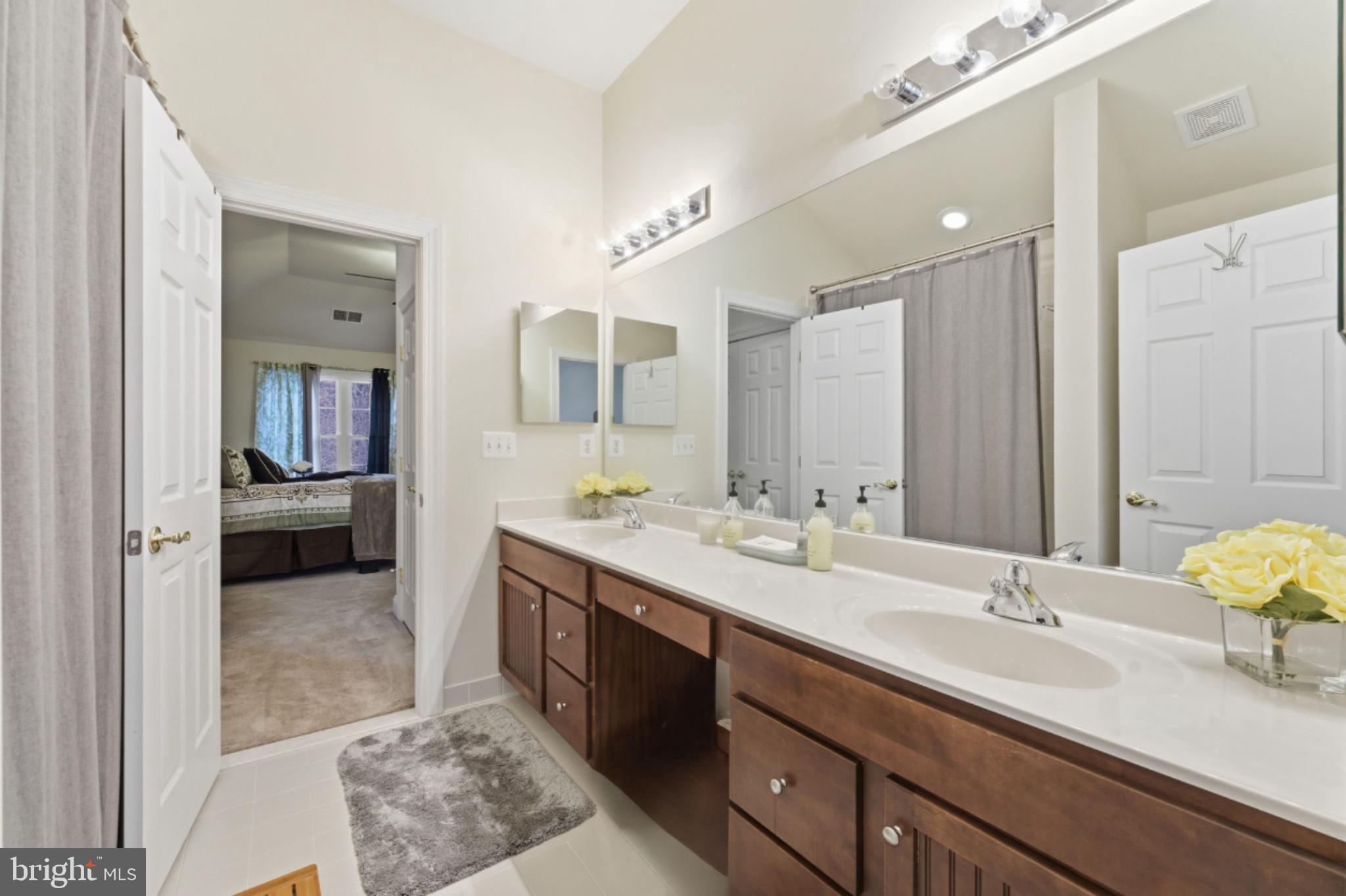 7669 Oak Field Court Springfield, VA 22153 - Photo 37 of 57 a spacious bathroom with a sink double vanity and a mirror