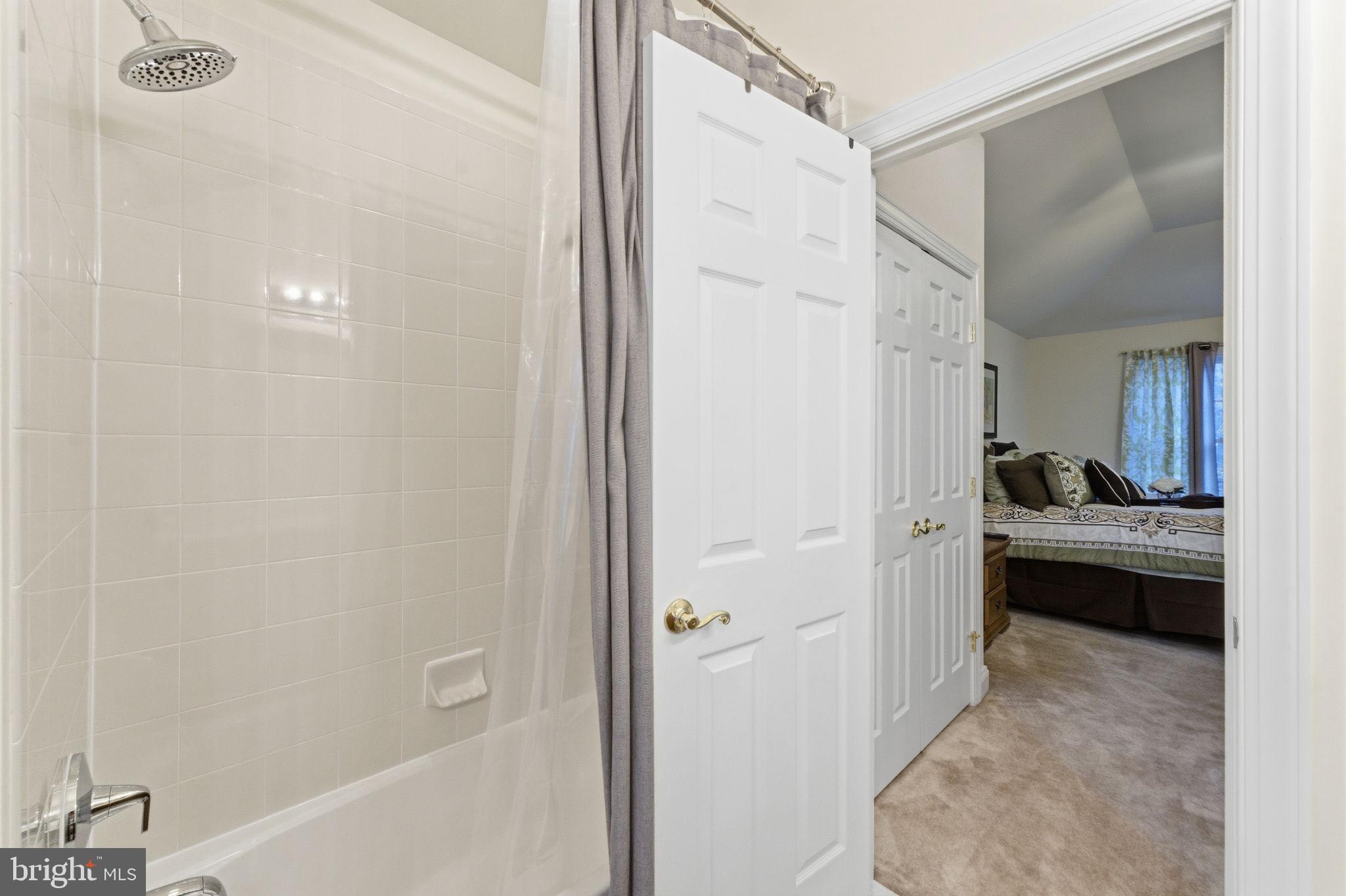 7669 Oak Field Court Springfield, VA 22153 - Photo 38 of 57 a bathroom with a tub sink shower and mirror
