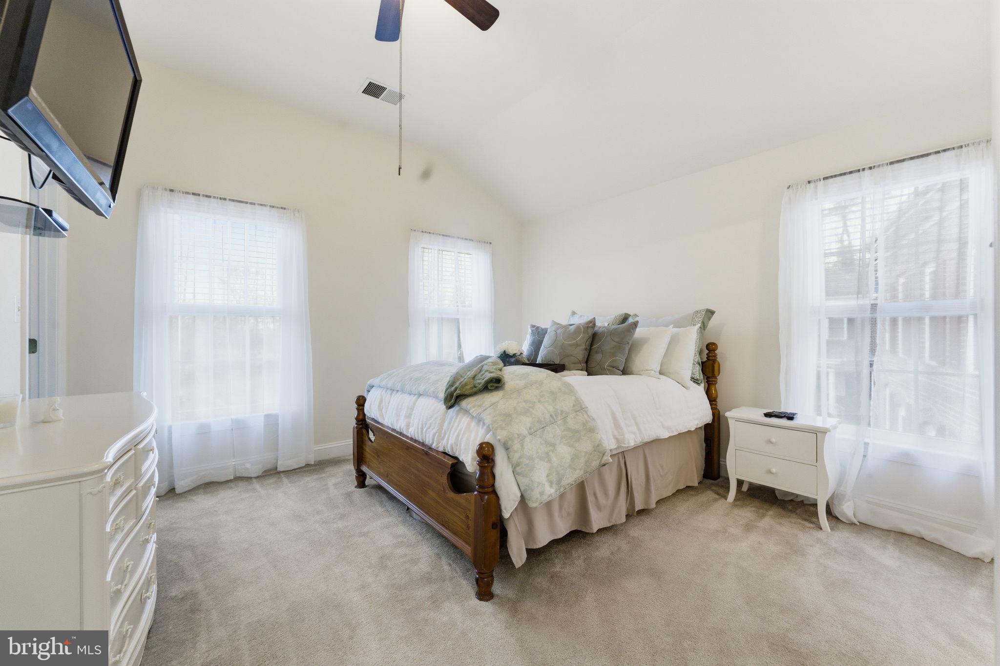 7669 Oak Field Court Springfield, VA 22153 - Photo 39 of 57 a spacious bedroom with a bed and a window