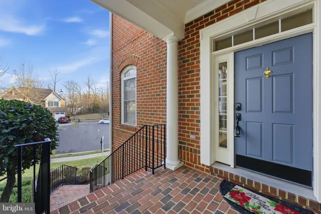 a view of an empty room with stairs and a ceiling fan