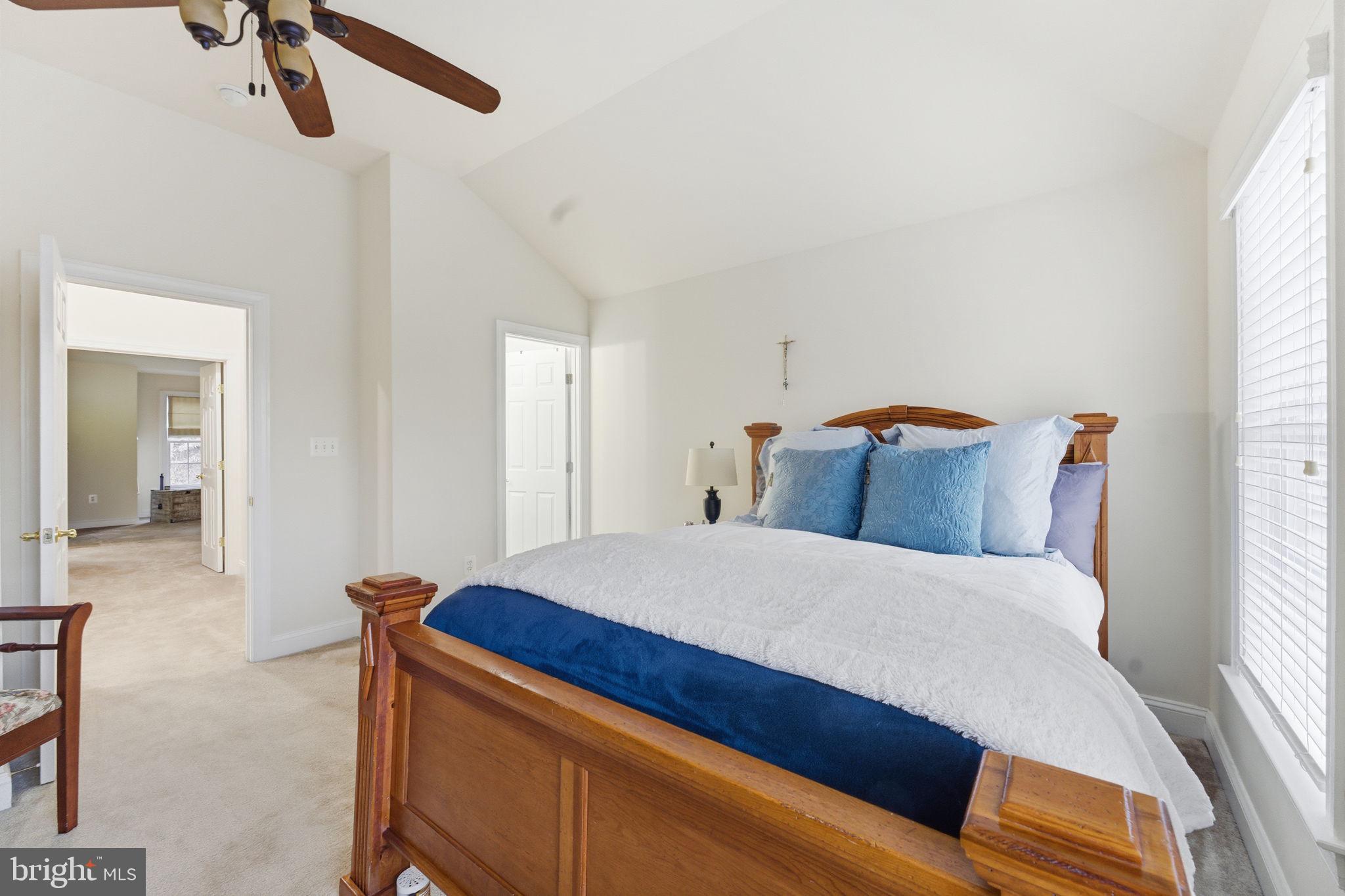 7669 Oak Field Court Springfield, VA 22153 - Photo 43 of 57 a bedroom with a bed and a chandelier