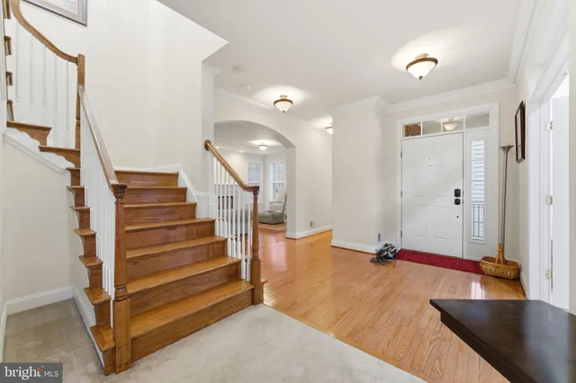 a kitchen with stainless steel appliances granite countertop a stove top oven a sink dishwasher a refrigerator and cabinets with wooden floor