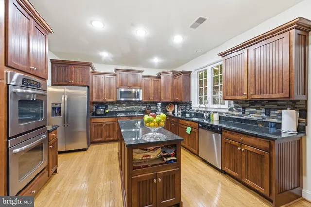 a dining room with furniture a chandelier and wooden floor