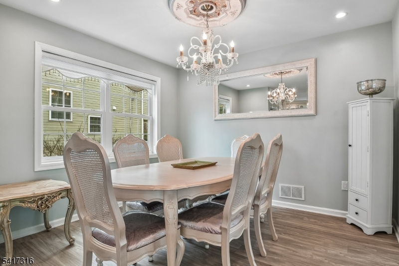 83 White Street Dover, NJ 07801 - Photo 12 of 26 a view of a dining room with furniture wooden floor and chandelier