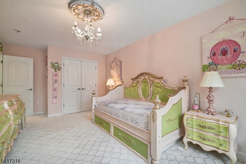 83 White Street Dover, NJ 07801 - Photo 17 of 26 a bedroom with a bed and a chandelier