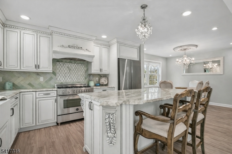 83 White Street Dover, NJ 07801 - Photo 2 of 26 a kitchen with stainless steel appliances granite countertop a stove refrigerator sink and cabinets