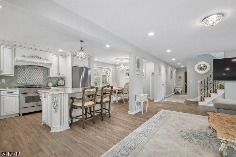 83 White Street Dover, NJ 07801 - Photo 6 of 26 a kitchen with stainless steel appliances kitchen island granite countertop a table chairs sink and cabinets