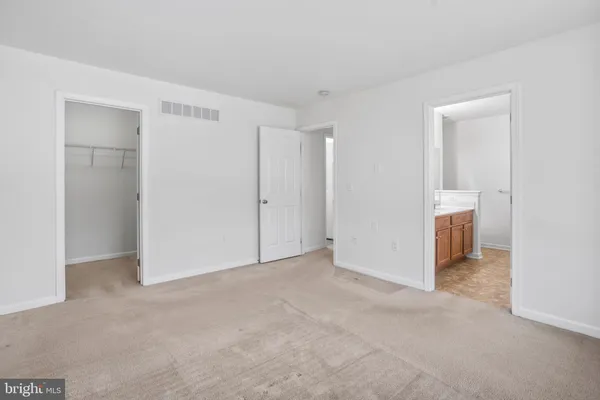 a view of an empty room and closet area