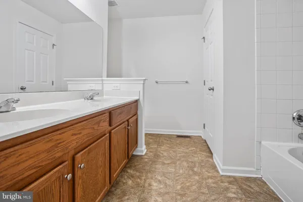 a spacious bathroom with a sink a mirror and a bathtub