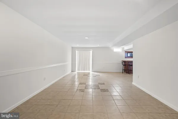 a view of a livingroom with an empty space and a window