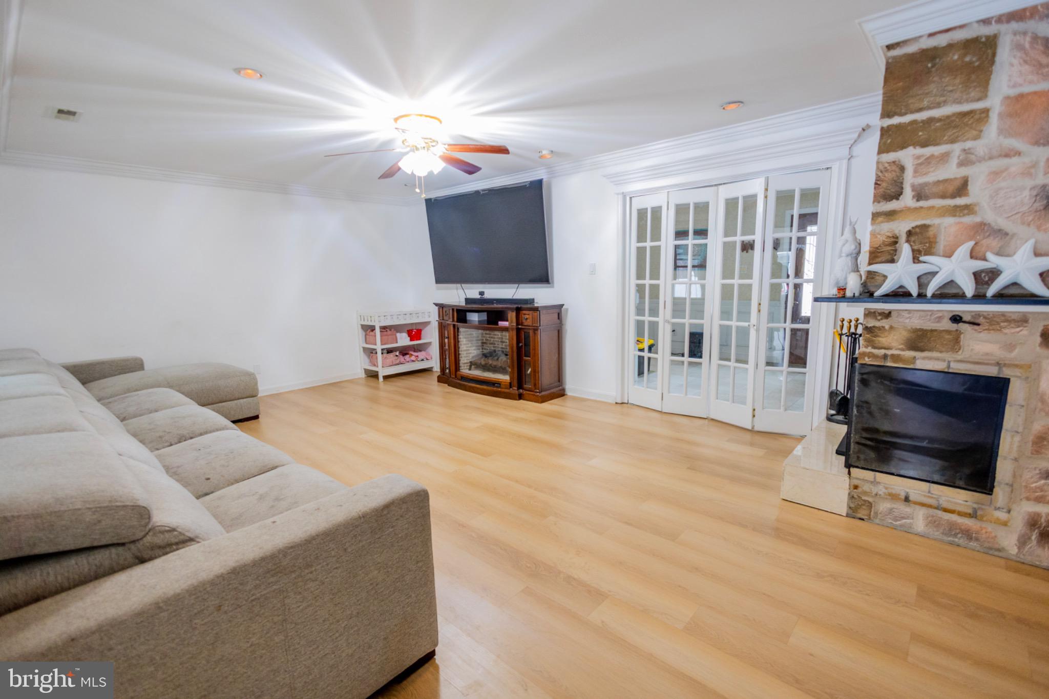 24 Rose Apple Road Levittown, PA 19056 - Photo 6 of 24 a living room with furniture a flat screen tv and a fireplace