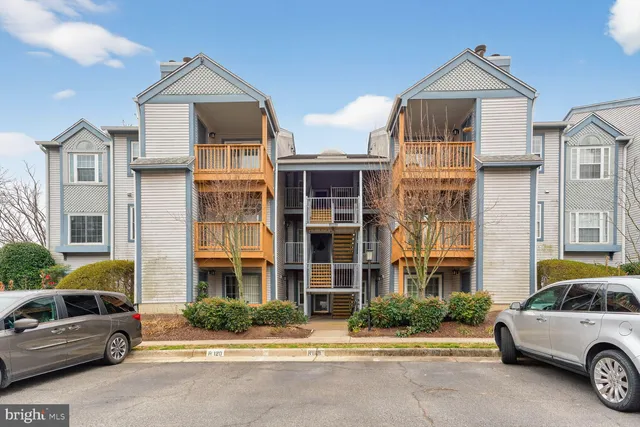 a front view of a residential apartment building with a yard