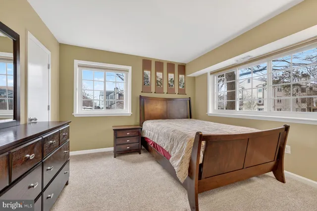 a spacious bedroom with a bed and a large window