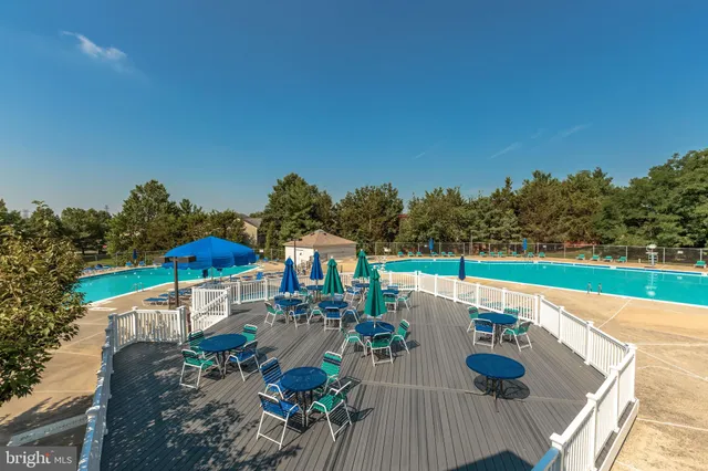 a view of a two room with furniture and wooden floor