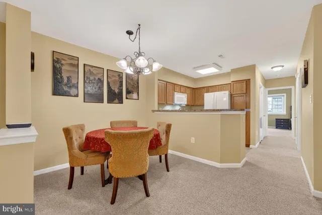 a view of a dining room with furniture and chandelier