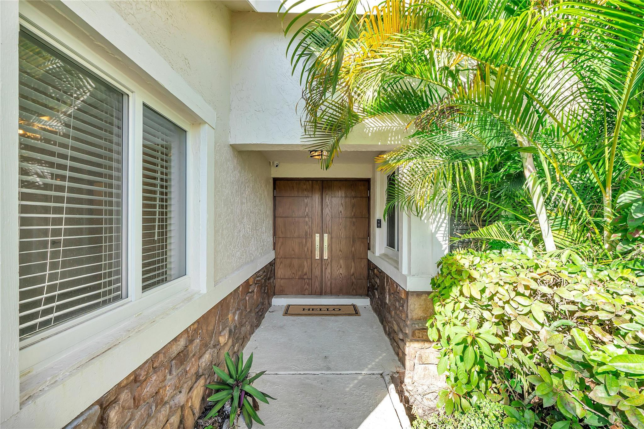 3605 Southwest 23rd Street Delray Beach, FL 33445 - Photo 43 of 50 a view of a pathway of a house with potted plants