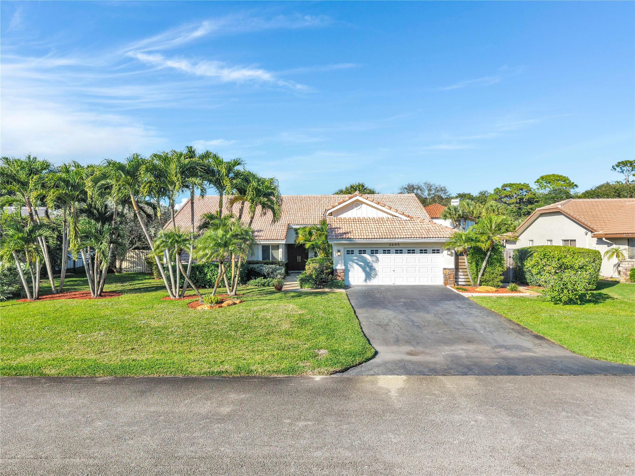 3605 Southwest 23rd Street Delray Beach, FL 33445 - Photo 45 of 50 a front view of a house with a yard and garage