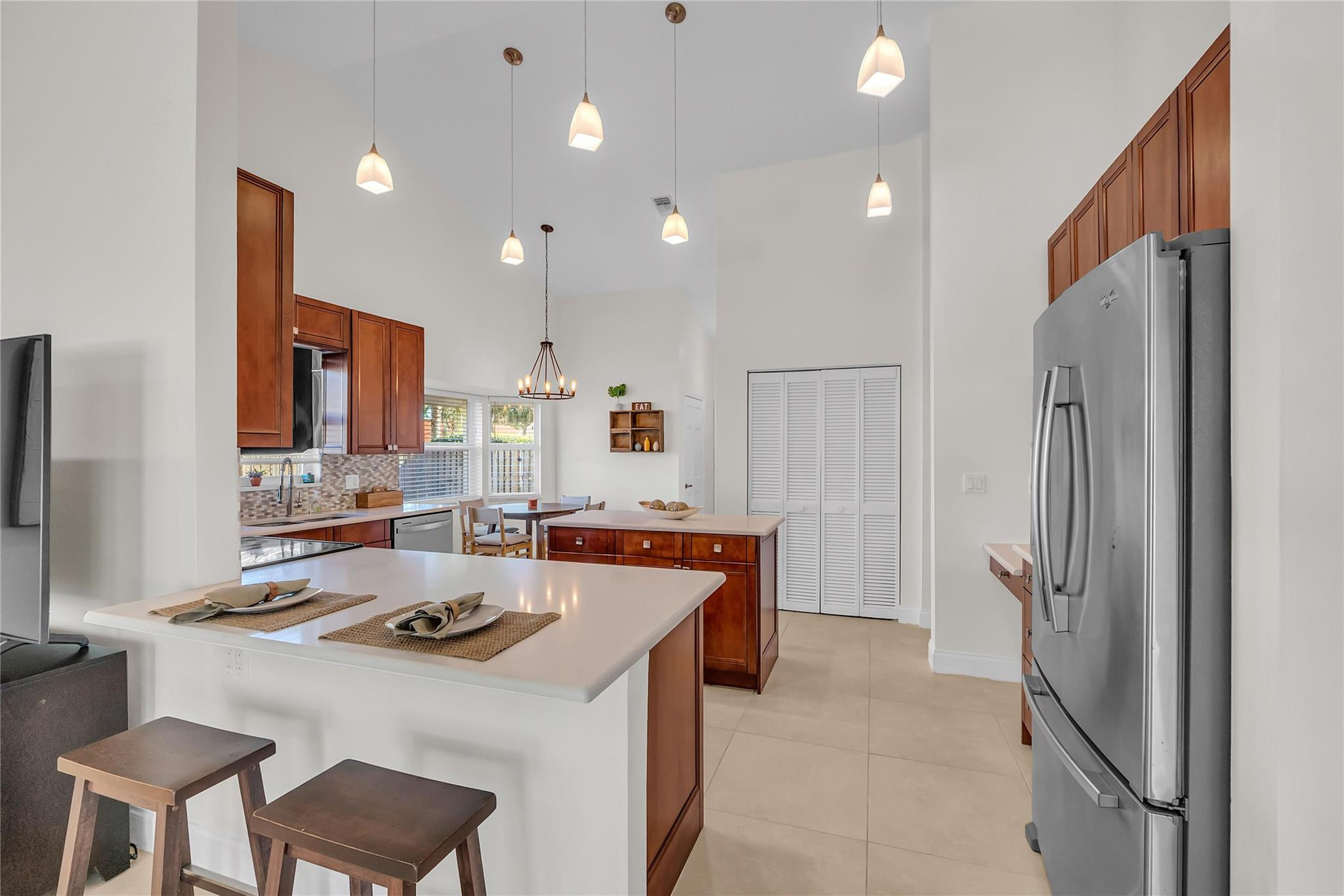 3605 Southwest 23rd Street Delray Beach, FL 33445 - Photo 6 of 50 a kitchen with a stove a refrigerator and a sink