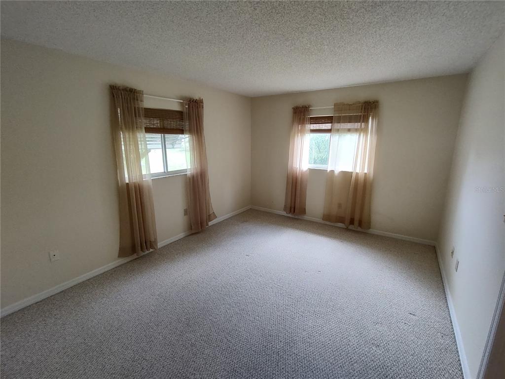 6345 Southwest 115th Street Road Ocala, FL 34476 - Photo 6 of 10 an empty room with windows