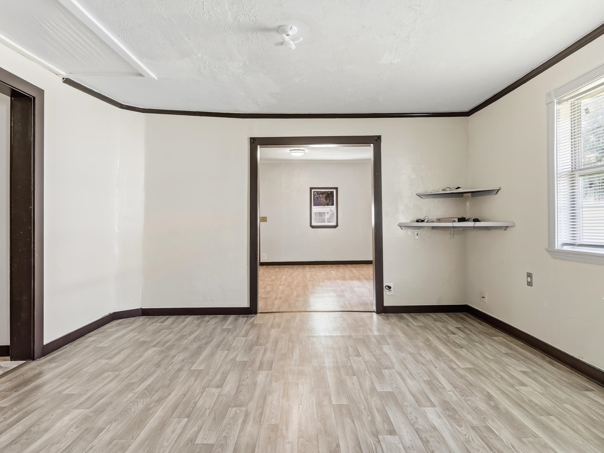 737 9th Street Port Arthur, TX 77640 - Photo 10 of 20 an empty room with wooden floor and windows