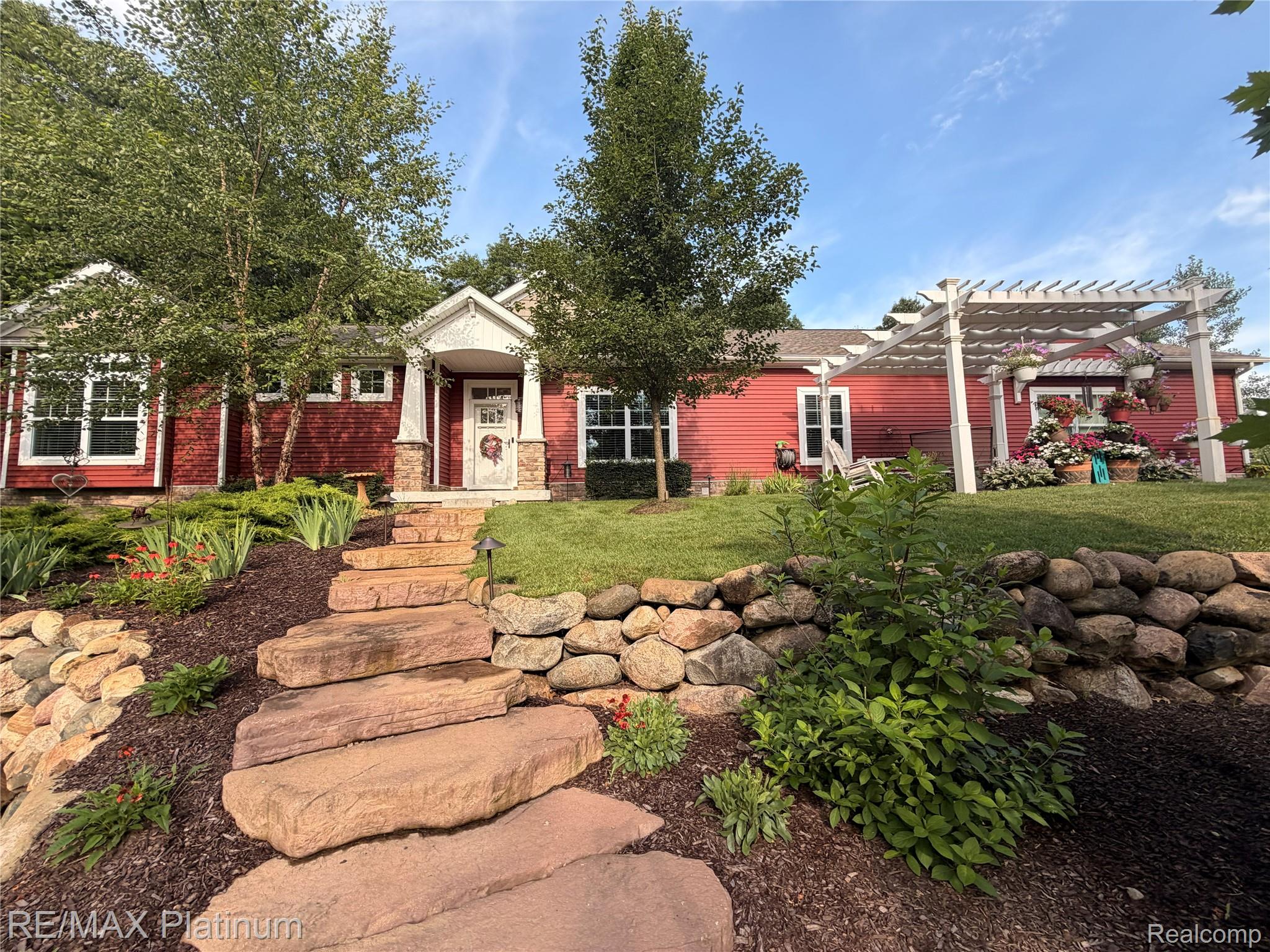 2676 Crooked Lake Road Howell, MI 48843 - Photo 1 of 60 Red siding exterior with white trim windows and a covered entry