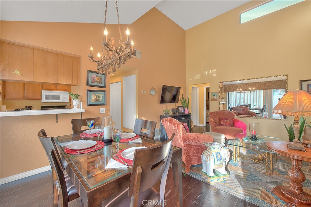 8576 Salina Street Rancho Cucamonga, CA 91730 - Photo 11 of 33 a view of a dining room with furniture a chandelier and wooden floor