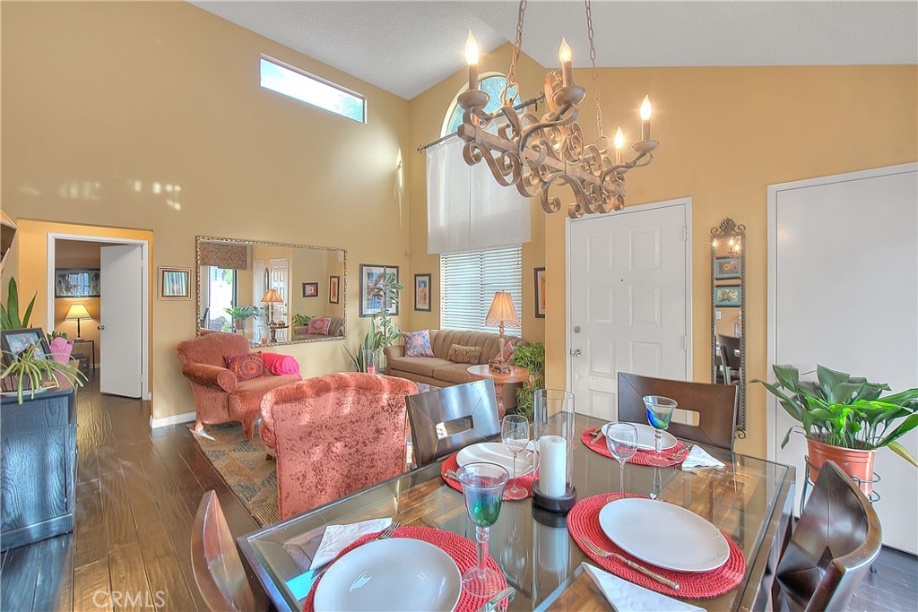 8576 Salina Street Rancho Cucamonga, CA 91730 - Photo 12 of 33 a living room with furniture a chandelier and a dining room
