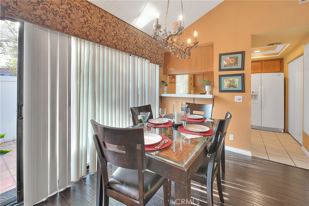 8576 Salina Street Rancho Cucamonga, CA 91730 - Photo 13 of 33 a view of a dining room with furniture and wooden floor