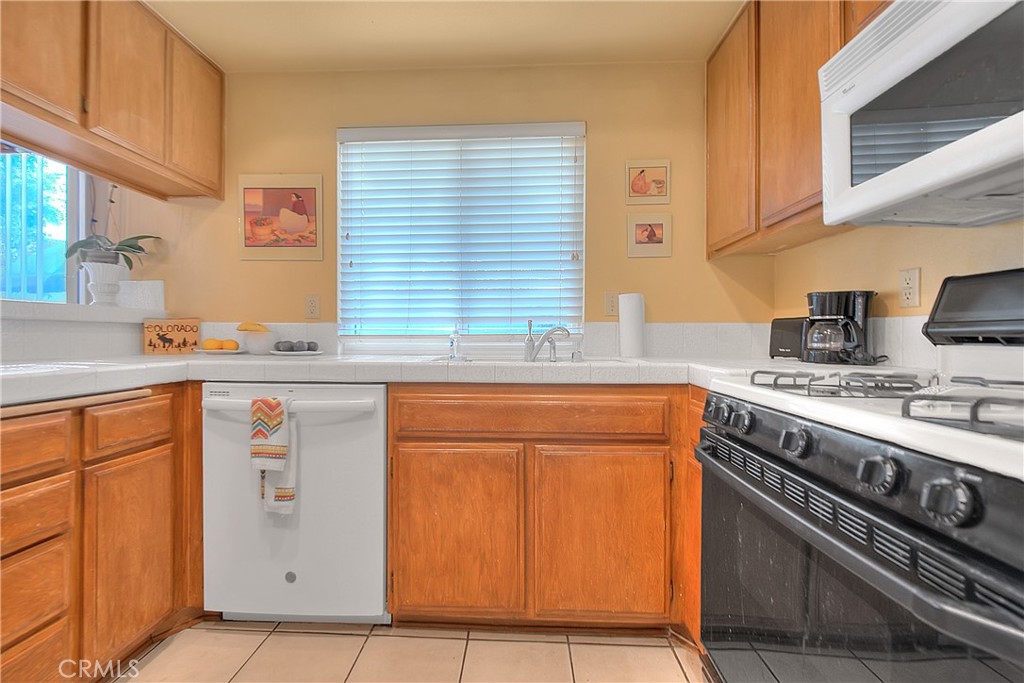 8576 Salina Street Rancho Cucamonga, CA 91730 - Photo 14 of 33 a kitchen with stainless steel appliances granite countertop a stove sink and cabinets