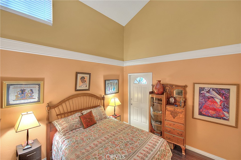 8576 Salina Street Rancho Cucamonga, CA 91730 - Photo 21 of 33 a bedroom with a large bed and a lamp