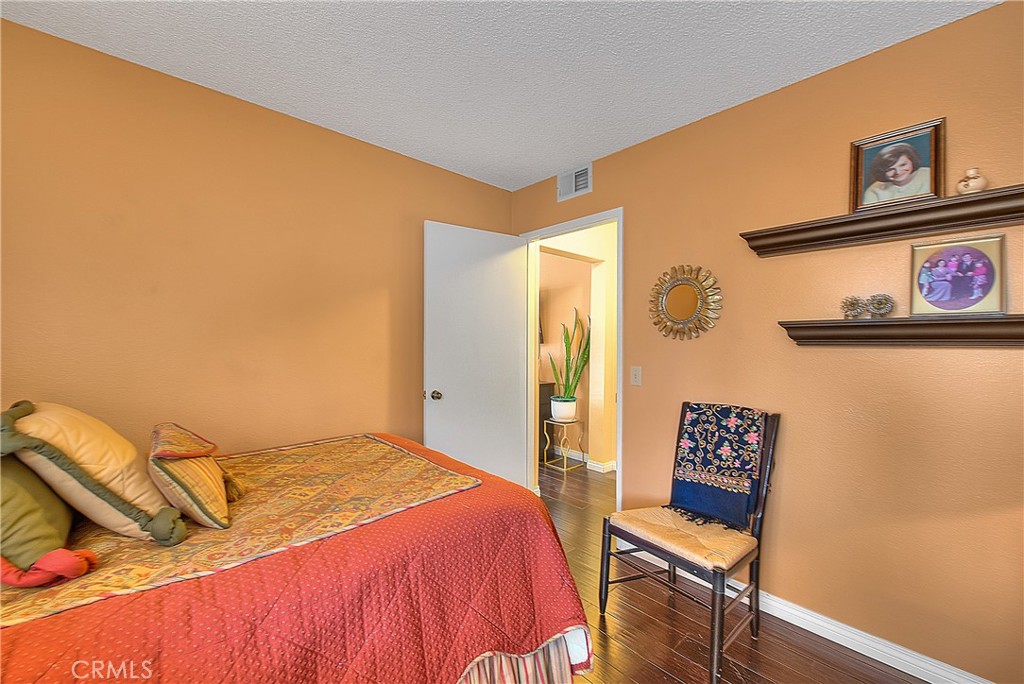 8576 Salina Street Rancho Cucamonga, CA 91730 - Photo 24 of 33 a bedroom with a bed and cupboard