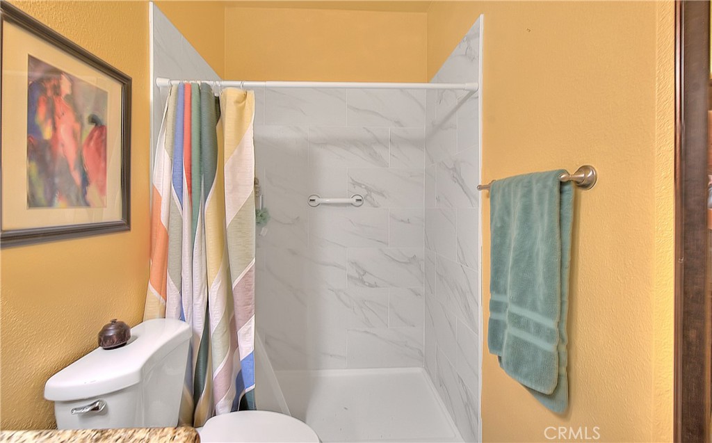 8576 Salina Street Rancho Cucamonga, CA 91730 - Photo 29 of 33 a bathroom with a shower and toilet