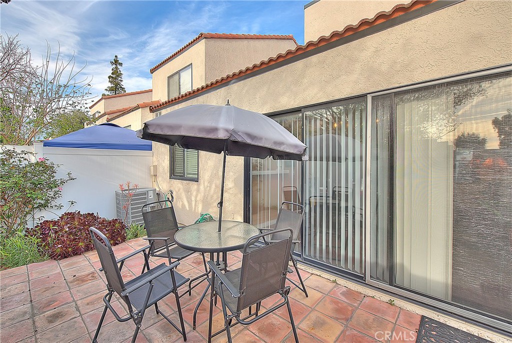 8576 Salina Street Rancho Cucamonga, CA 91730 - Photo 30 of 33 a patio with a table and chairs and potted plants