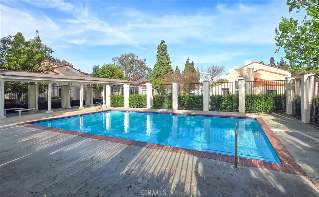 8576 Salina Street Rancho Cucamonga, CA 91730 - Photo 33 of 33 a view of pool with large windows and a yard with plants