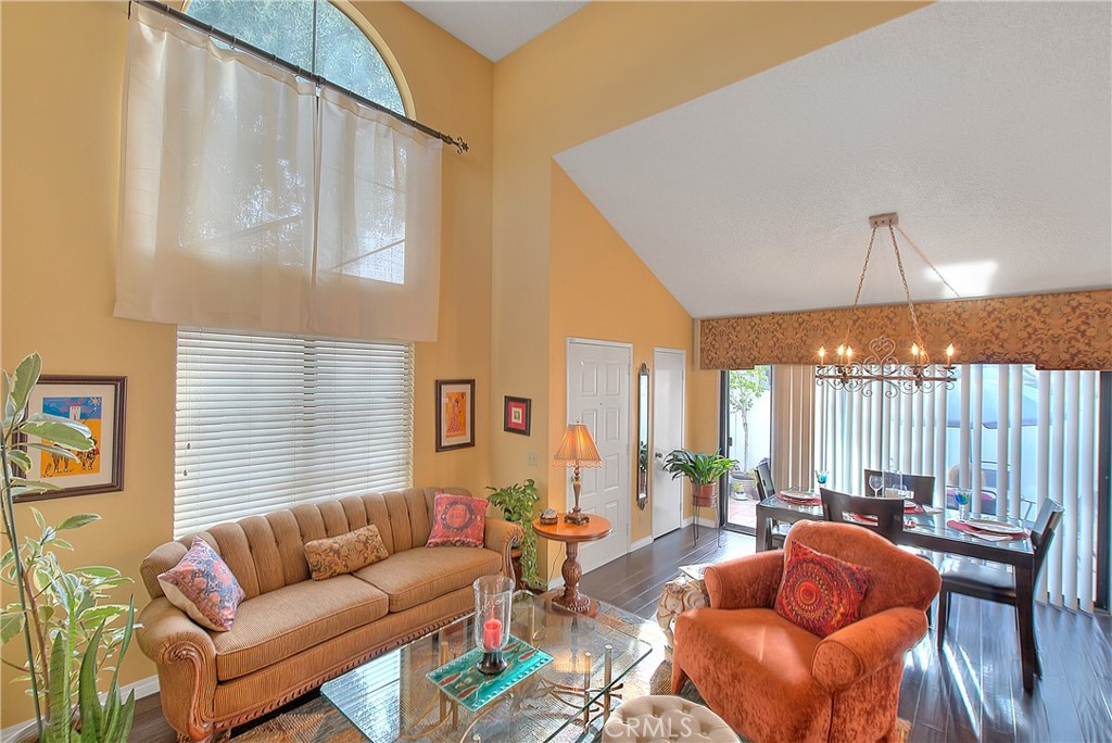 8576 Salina Street Rancho Cucamonga, CA 91730 - Photo 7 of 33 a living room with furniture a large window and a chandelier