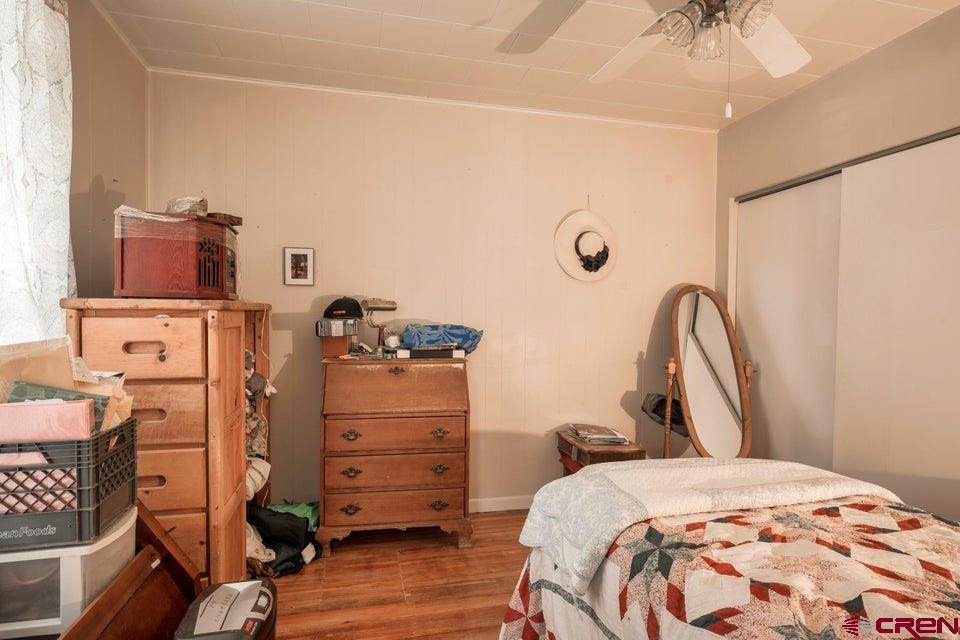 603 East First Street Trinidad, CO 81082 - Photo 13 of 37 a bedroom with a bed and a chandelier