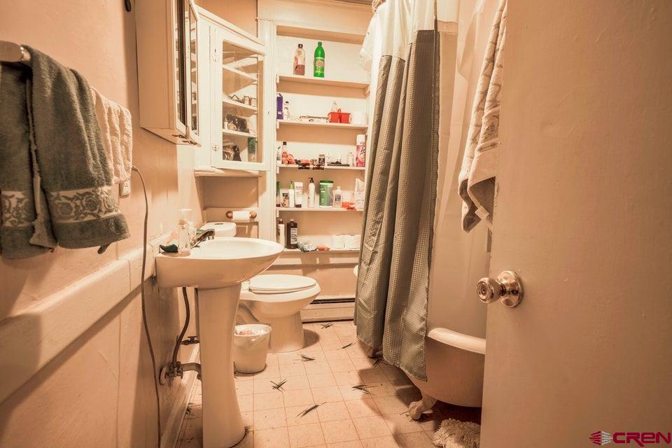 603 East First Street Trinidad, CO 81082 - Photo 14 of 37 a bathroom with a sink toilet and shower