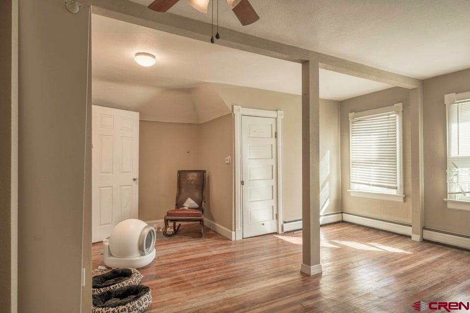 603 East First Street Trinidad, CO 81082 - Photo 16 of 37 a room that has a window and wooden floor