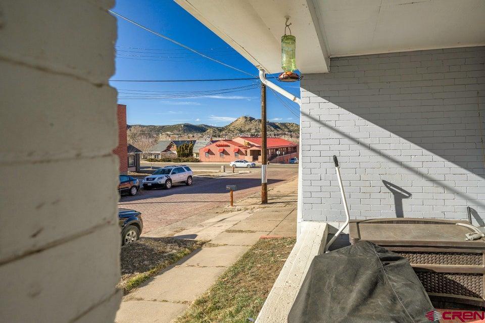 603 East First Street Trinidad, CO 81082 - Photo 19 of 37 a view of a balcony with wooden floor and bench