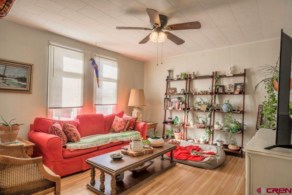 603 East First Street Trinidad, CO 81082 - Photo 22 of 37 a living room with furniture a flat screen tv and a window