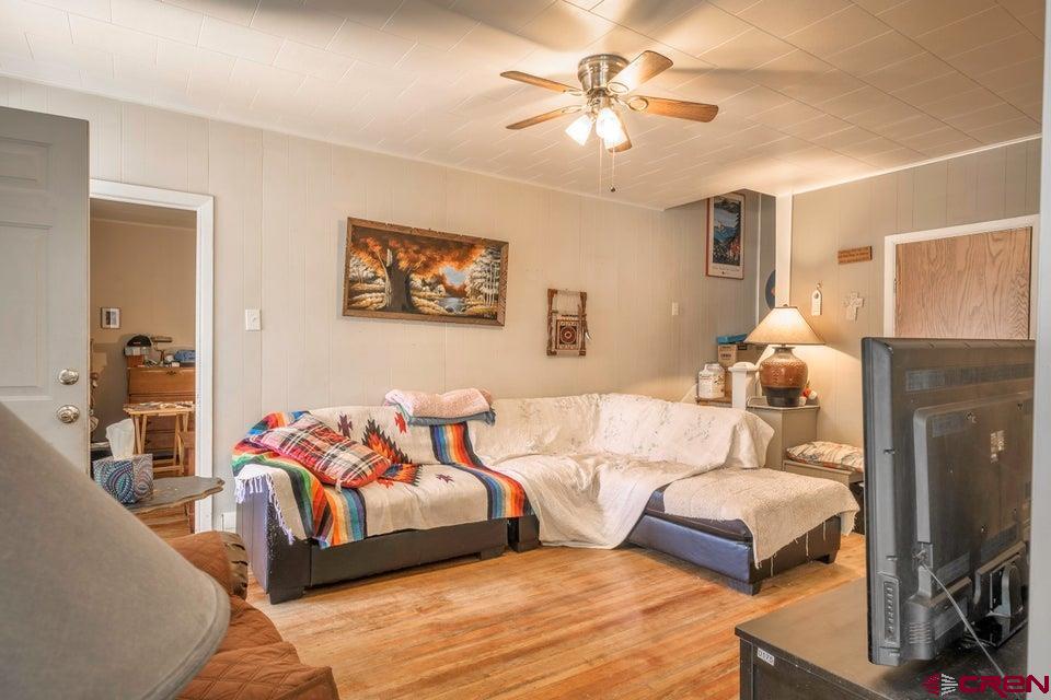 603 East First Street Trinidad, CO 81082 - Photo 26 of 37 a bedroom with furniture and a chandelier