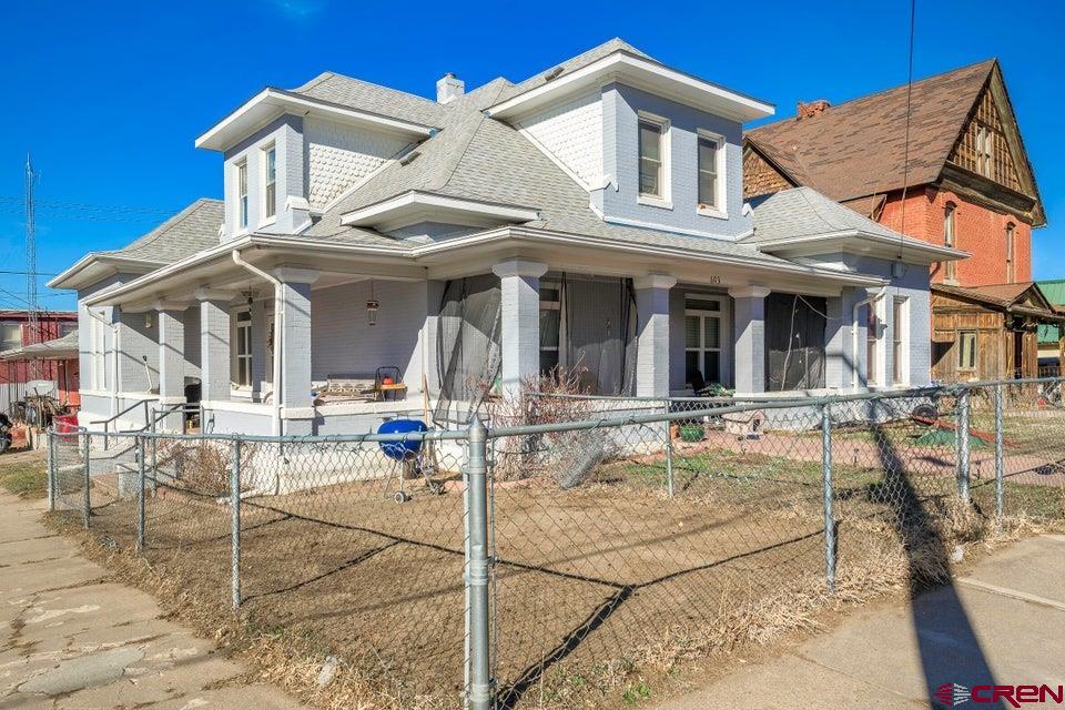 603 East First Street Trinidad, CO 81082 - Photo 37 of 37 a view of a white house with swimming pool table and chairs
