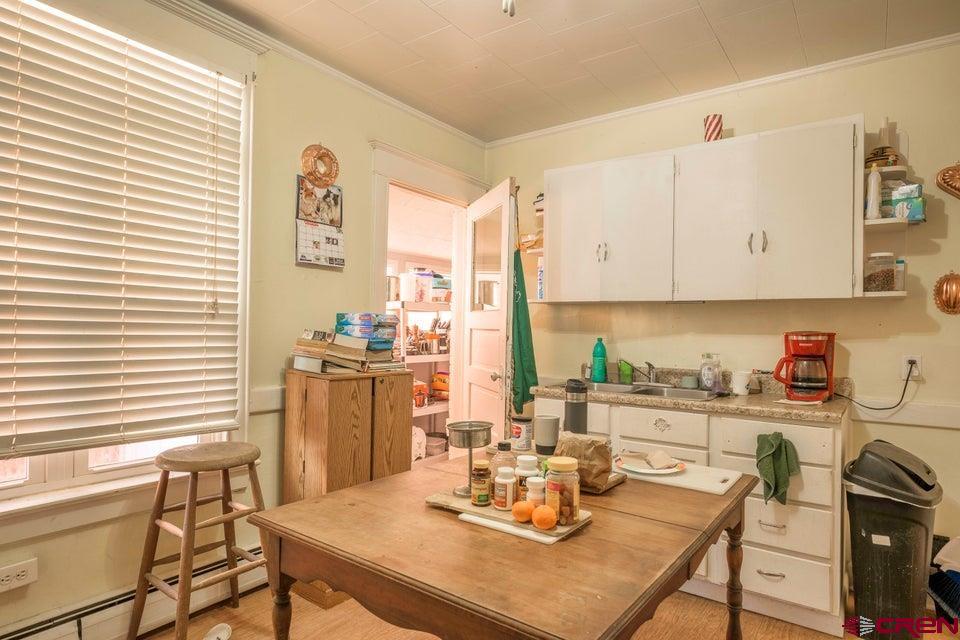 603 East First Street Trinidad, CO 81082 - Photo 9 of 37 a kitchen with a table chairs and a stove top oven