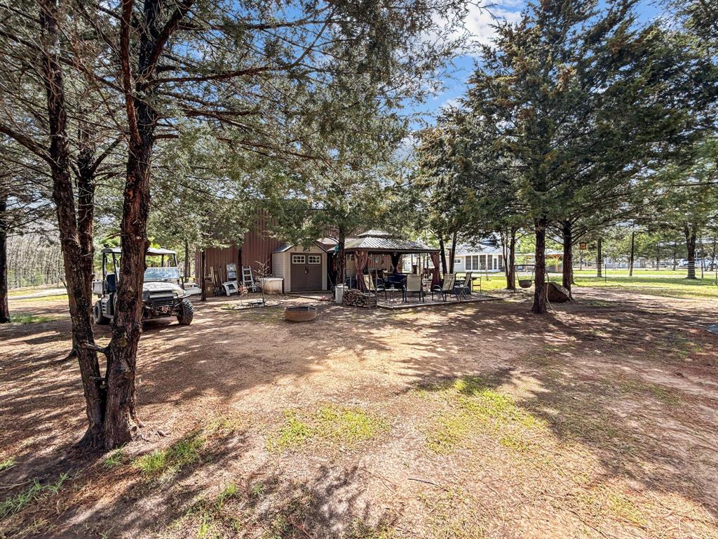 1477 Cedar Mills Road Gordonville, TX 76245 - Photo 18 of 21 View of yard with an outbuilding, a gazebo, and a shed